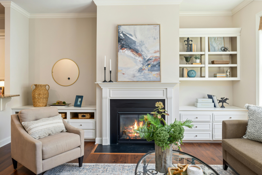 A clean, well-kept living room with a fireplace, comfortable seating, and warm natural light